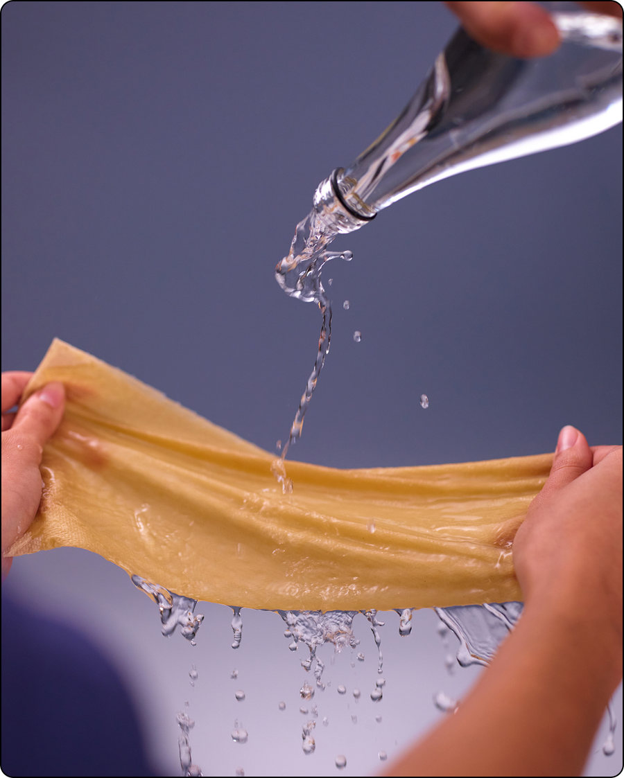 Shot of water being poured on a sheet of PlantPaper Towel