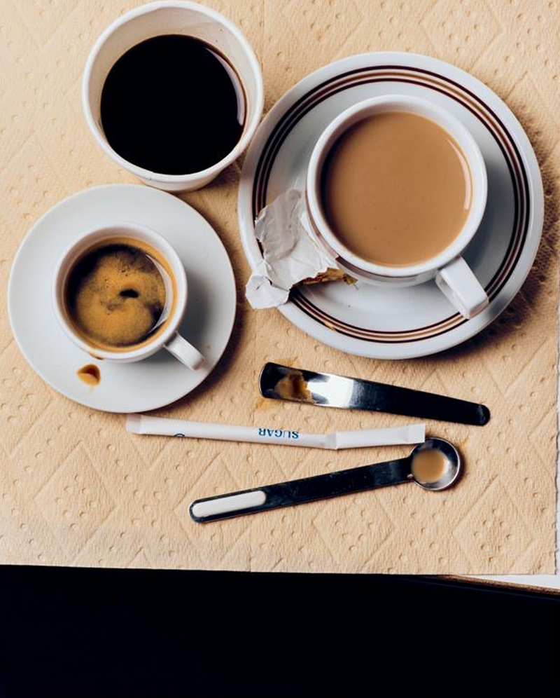 PlantPaper Towel beside coffee cups and spoons on a textured kitchen table