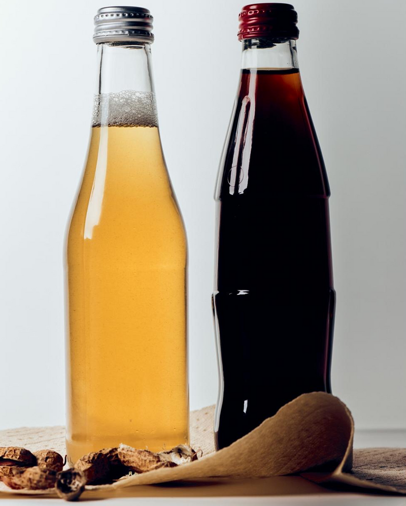 Close-up of PlantPaper Towel showcasing its draped sheet beside two glass bottles on a neutral surface